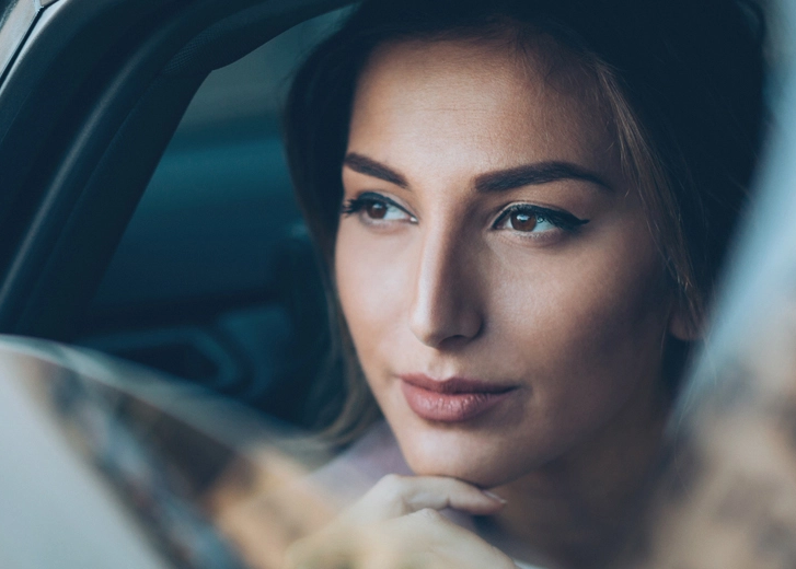 Woman looking out a car window